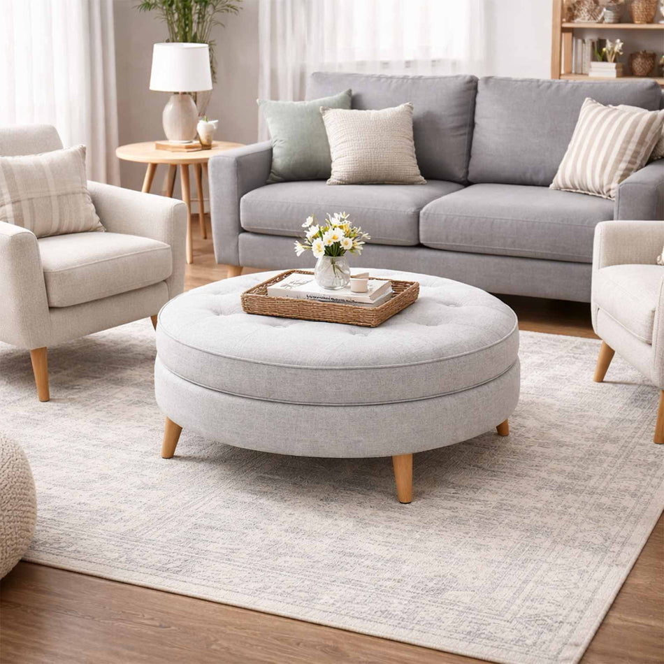 Round button-detailed ottoman with wooden legs