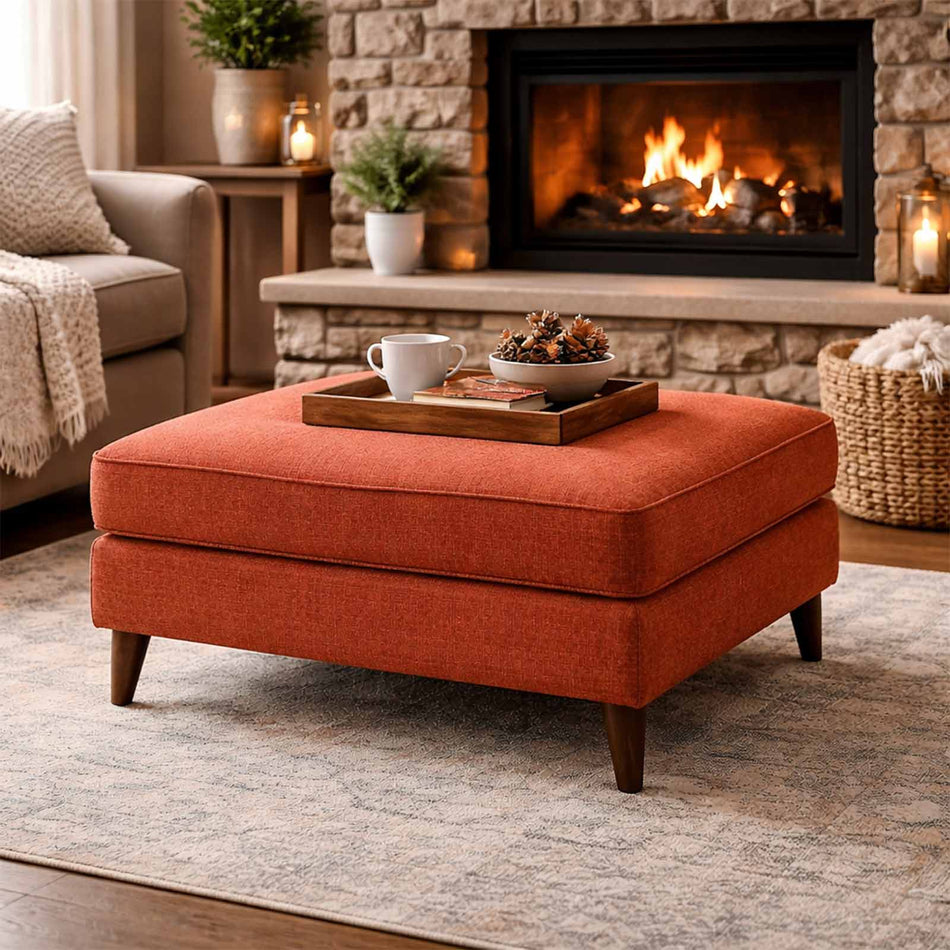 Cushioned ottoman with tapered wooden legs